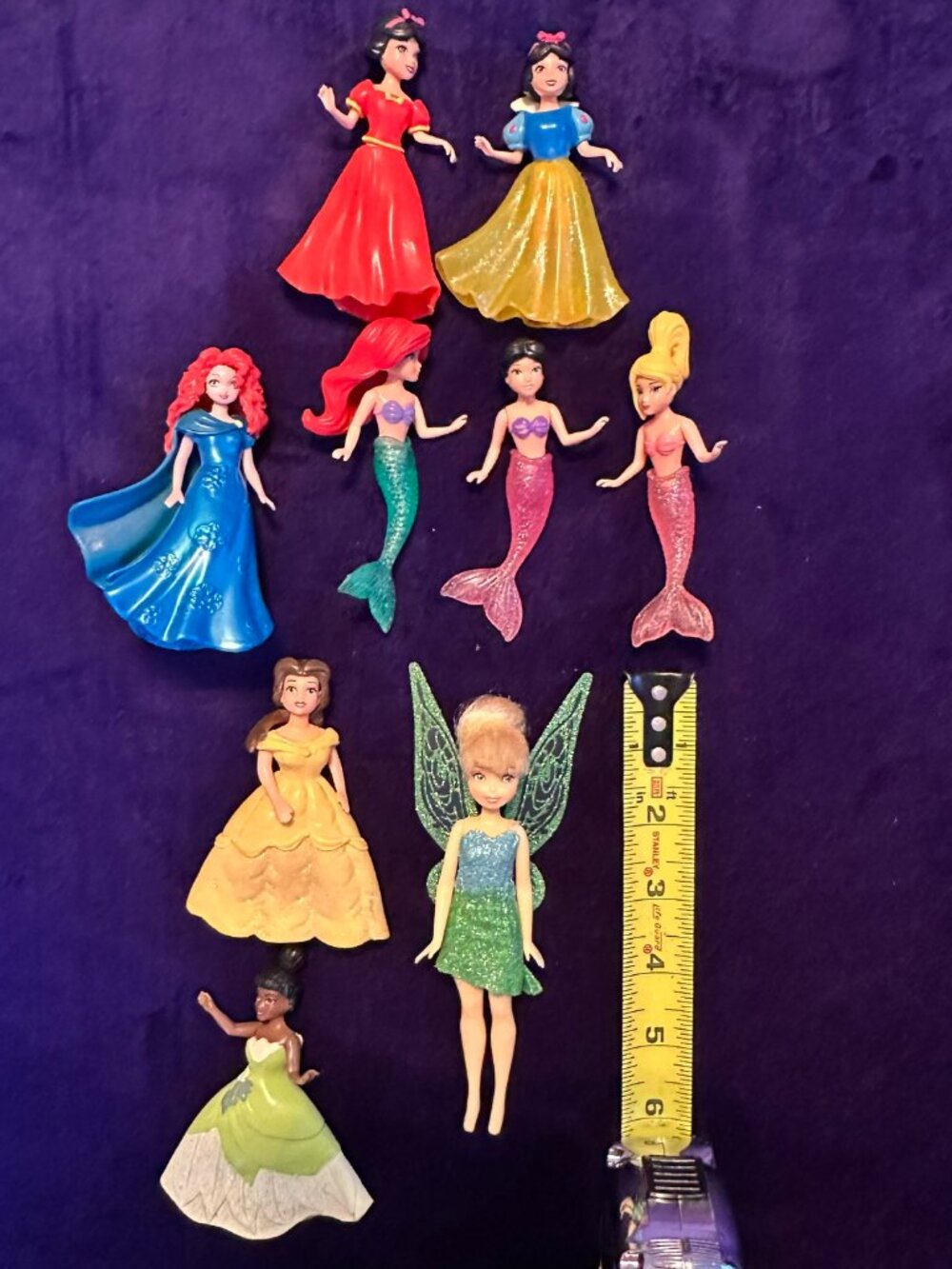 Nine plastic Disney dolls